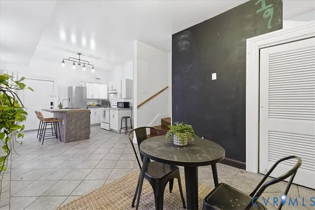 a view of a dining room with furniture and chandelier