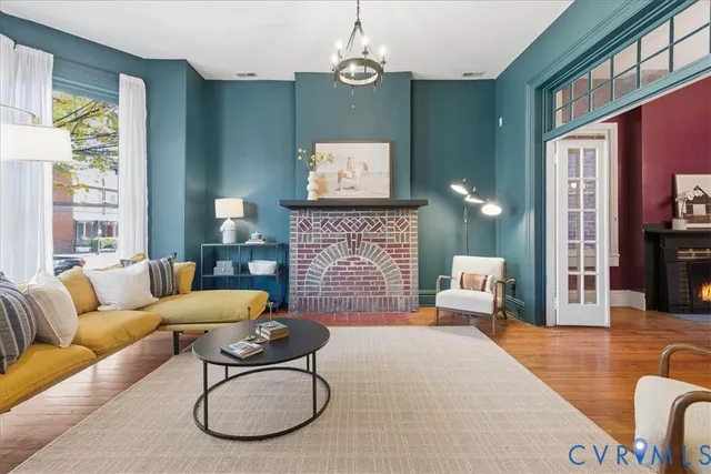 a living room with furniture a couch and a chandelier