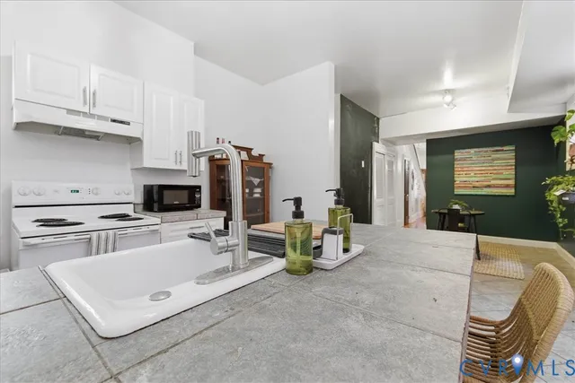 a kitchen with stainless steel appliances kitchen island granite countertop a sink and cabinets