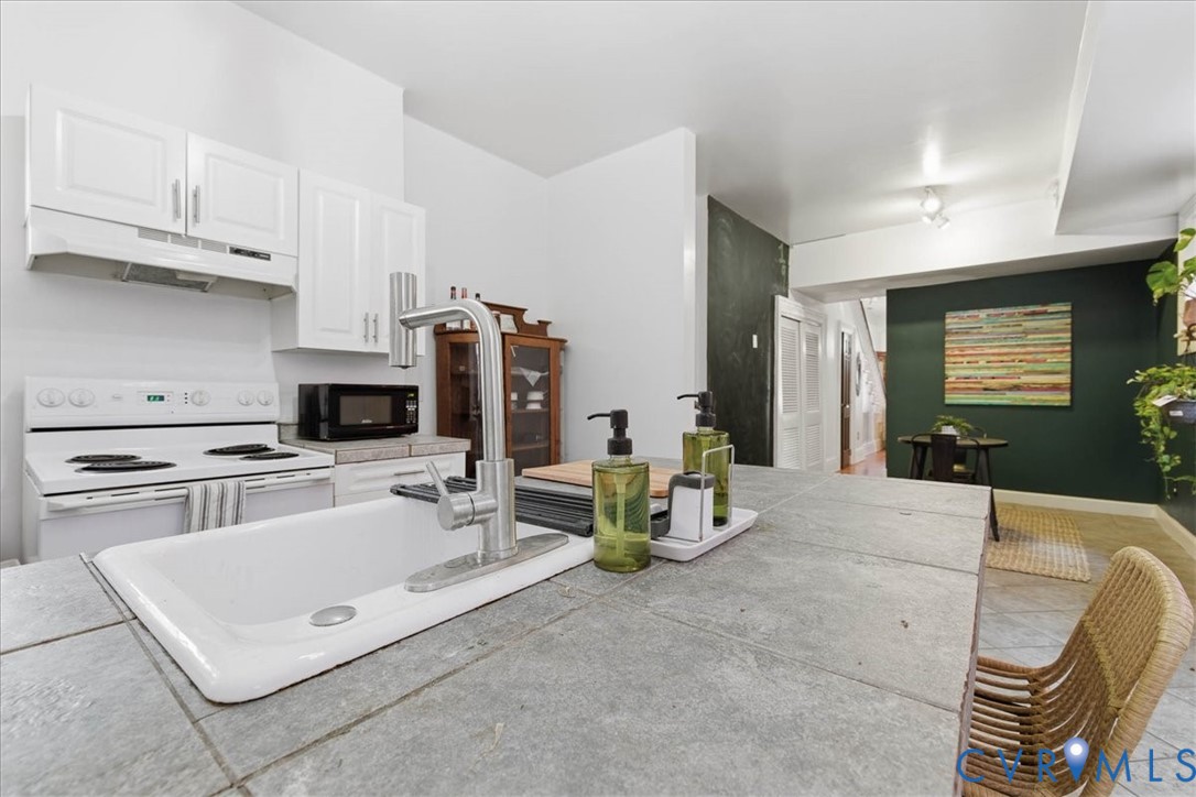 19 East Clay Street Richmond, VA 23219 - Photo 10 of 31 a kitchen with stainless steel appliances kitchen island granite countertop a sink and cabinets