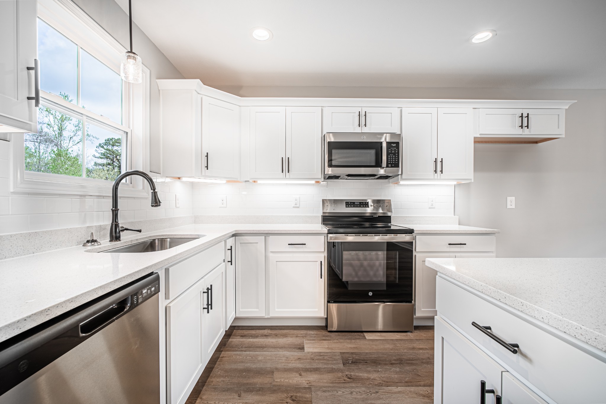 46 Bunker Hill Road Clarksville, TN 37042 - Photo 2 of 14 a kitchen with a sink stove and white cabinets