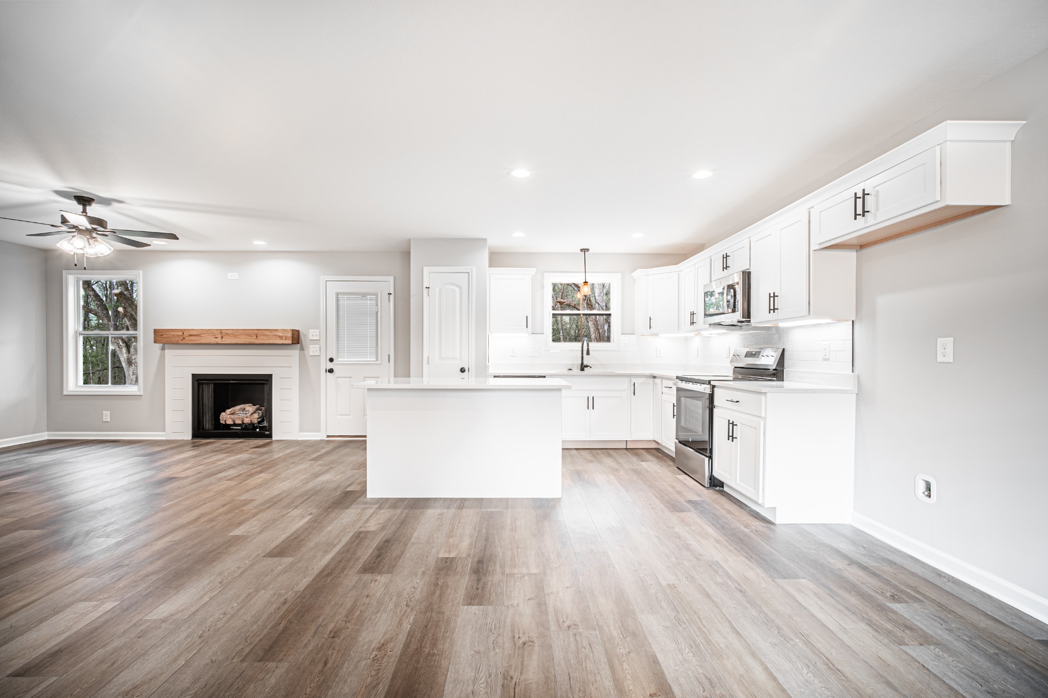 46 Bunker Hill Road Clarksville, TN 37042 - Photo 5 of 14 a large kitchen with cabinets wooden floor and a fireplace