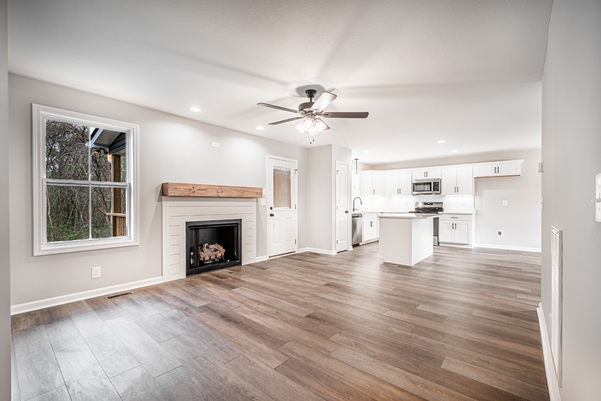 46 Bunker Hill Road Clarksville, TN 37042 - Photo 6 of 14 a view of an empty room with a fireplace and a window