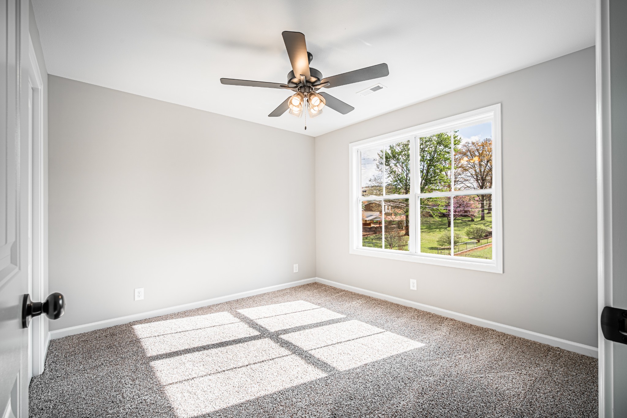 46 Bunker Hill Road Clarksville, TN 37042 - Photo 8 of 14 an empty room with windows and fan