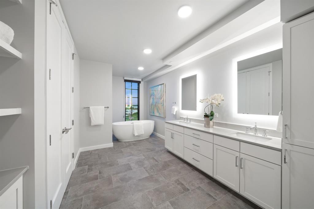 3111 Sunset Boulevard, Unit A01 Flower Mound, TX 75022 - Photo 12 of 39 a spacious bathroom with a double vanity sink a large mirror and a shower