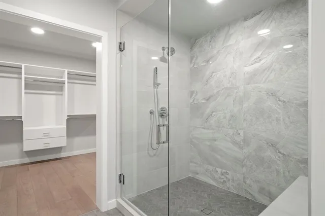 a bathroom with a double vanity sink toilet mirror and shower