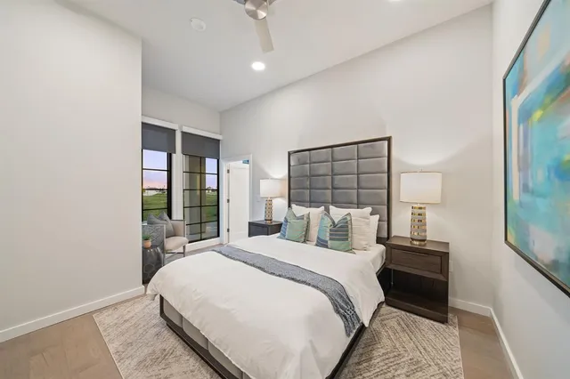 a view of empty room with kitchen and refrigerator