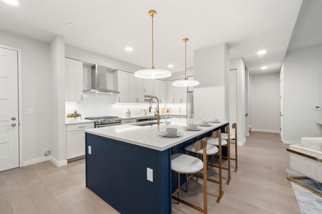 3111 Sunset Boulevard, Unit A01 Flower Mound, TX 75022 - Photo 5 of 39 a kitchen with stainless steel appliances kitchen island a sink and cabinets
