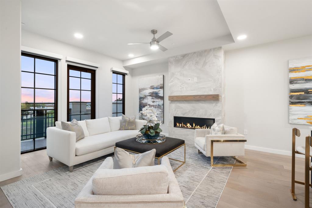 3111 Sunset Boulevard, Unit A01 Flower Mound, TX 75022 - Photo 7 of 39 a living room with furniture a fireplace and a large window