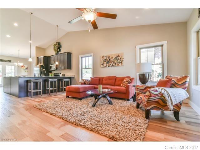 39 Ball Gap Road, Unit 2 Arden, NC 28704 - Photo 5 of 11 a living room with furniture and a flat screen tv