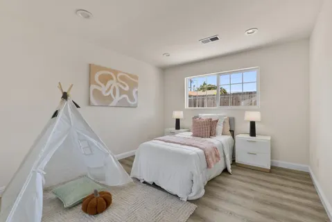 a bedroom with a bed and a window