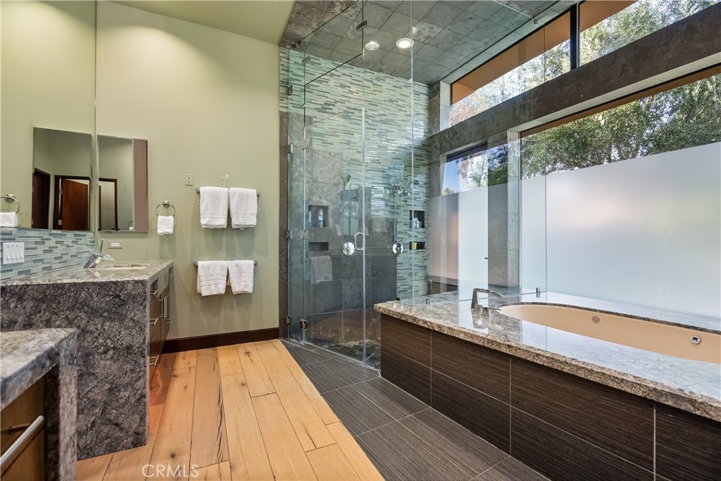 68 Royal St Georges Way Rancho Mirage, CA 92270 - Photo 50 of 75 a bathroom with a granite countertop sink and a large mirror