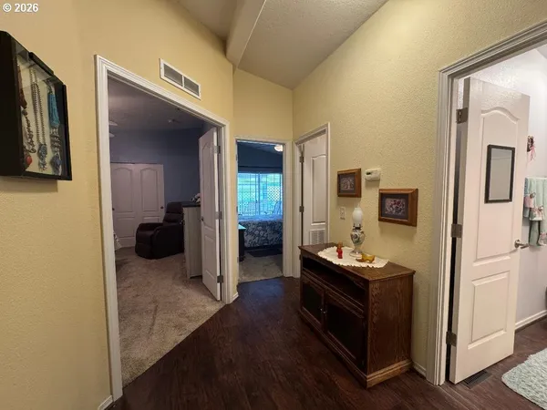a bathroom with a granite countertop sink a toilet a mirror and shower