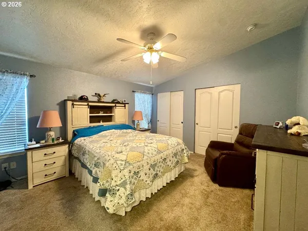 a bathroom with a granite countertop sink mirror vanity and toilet