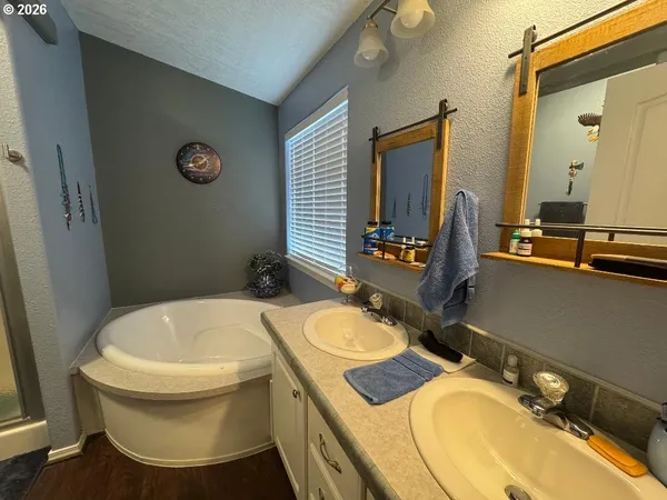 a bathroom with a granite countertop toilet and a shower