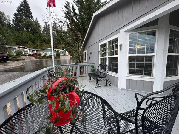 a roof deck with table and chairs and potted plants