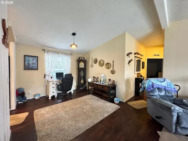 a dining room with furniture and wooden floor