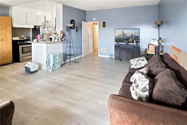 a living room with furniture and a kitchen