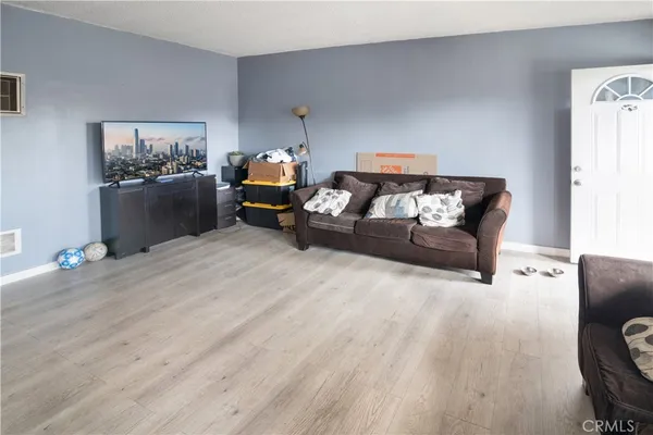 a bed room with furniture and wooden floor