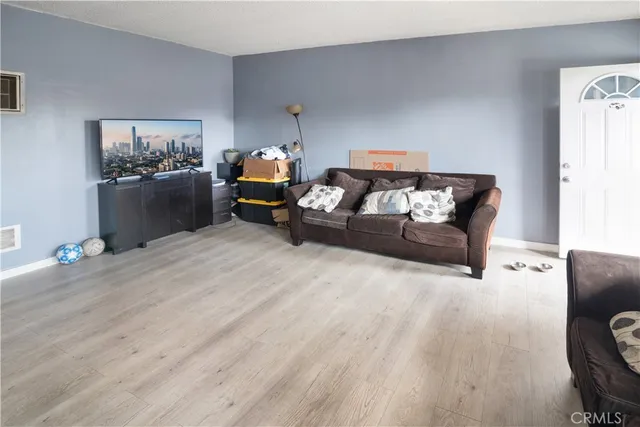 a bed room with furniture and wooden floor