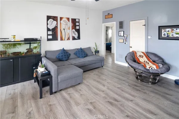 a living room with furniture a rug and a wall painting