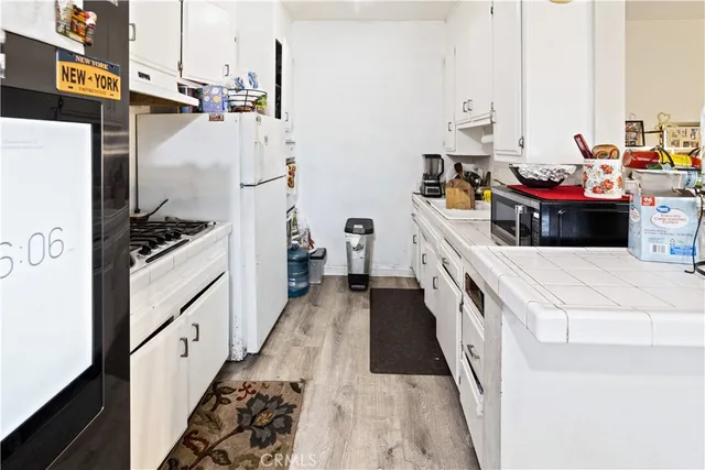 a kitchen with stove and refrigerator