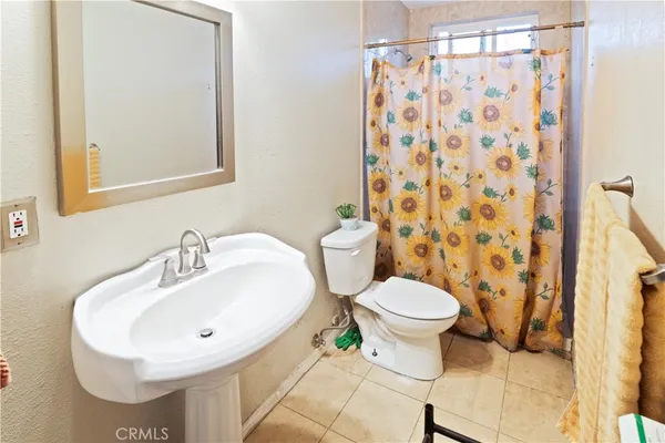 a bathroom with a sink toilet and a mirror