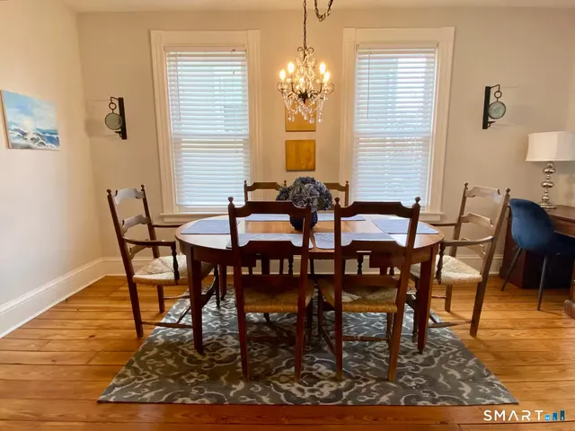 a view of a dining room with furniture and wooden floor