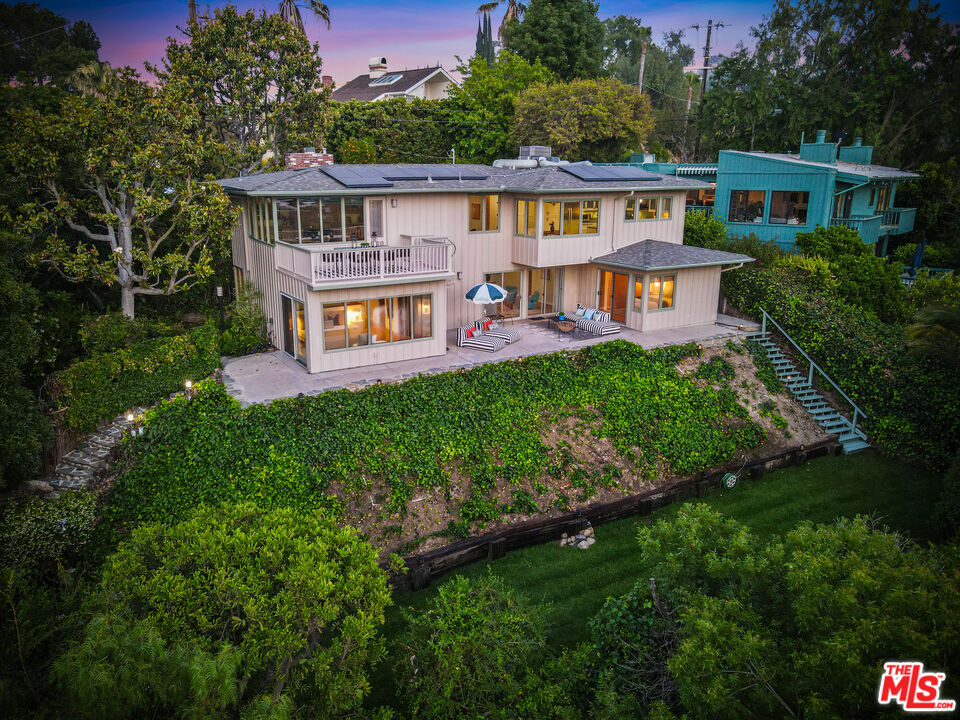13201 Cheltenham Drive Sherman Oaks, CA 91423 - Photo 2 of 75 a front view of a house with a garden and plants