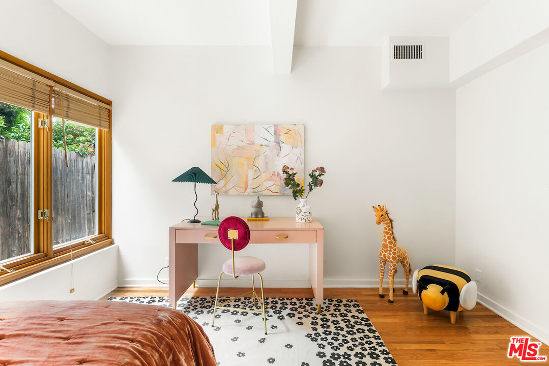 13201 Cheltenham Drive Sherman Oaks, CA 91423 - Photo 27 of 75 a bedroom with a bed and window