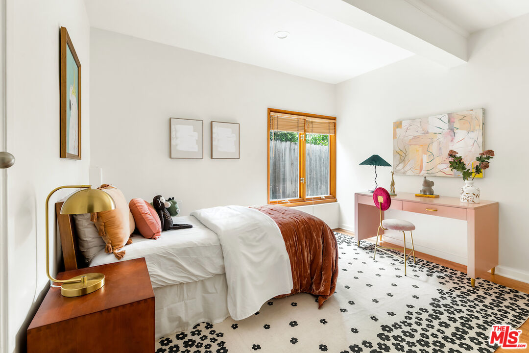 13201 Cheltenham Drive Sherman Oaks, CA 91423 - Photo 28 of 75 a bedroom with a bed and wooden floor