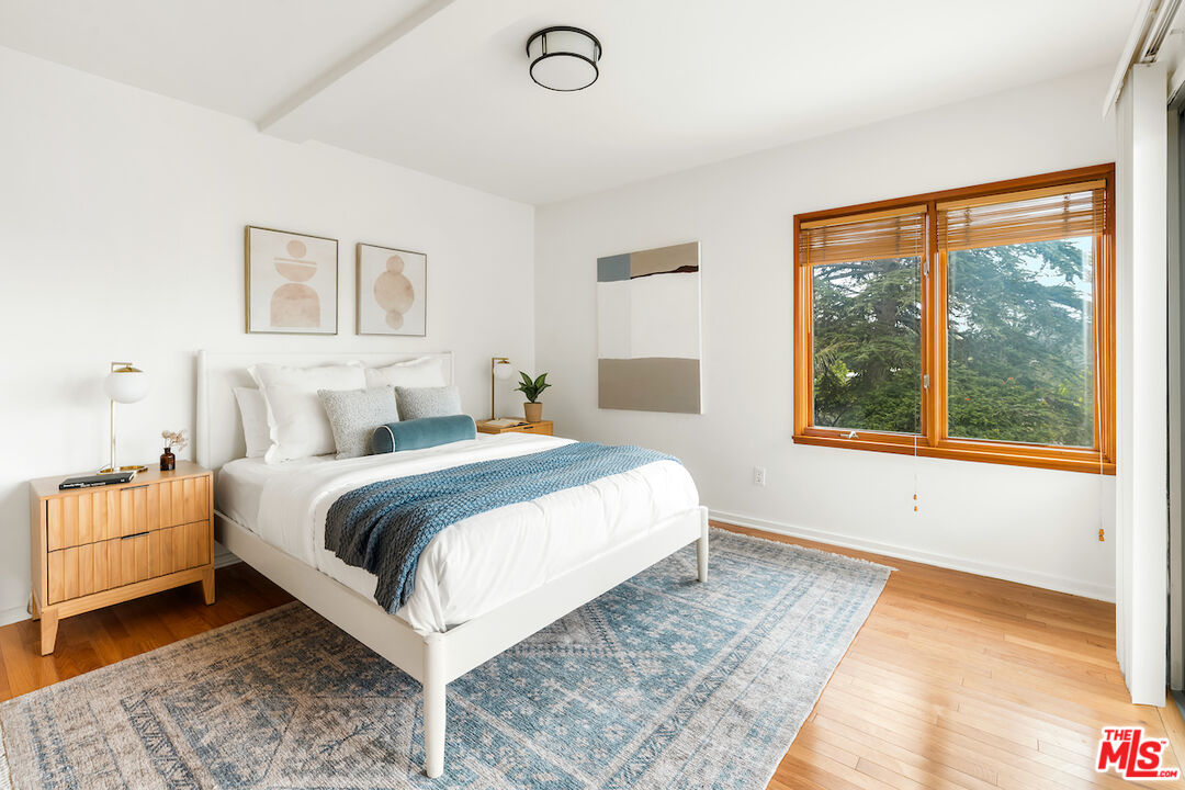 13201 Cheltenham Drive Sherman Oaks, CA 91423 - Photo 30 of 75 a bedroom with a large bed and a large window