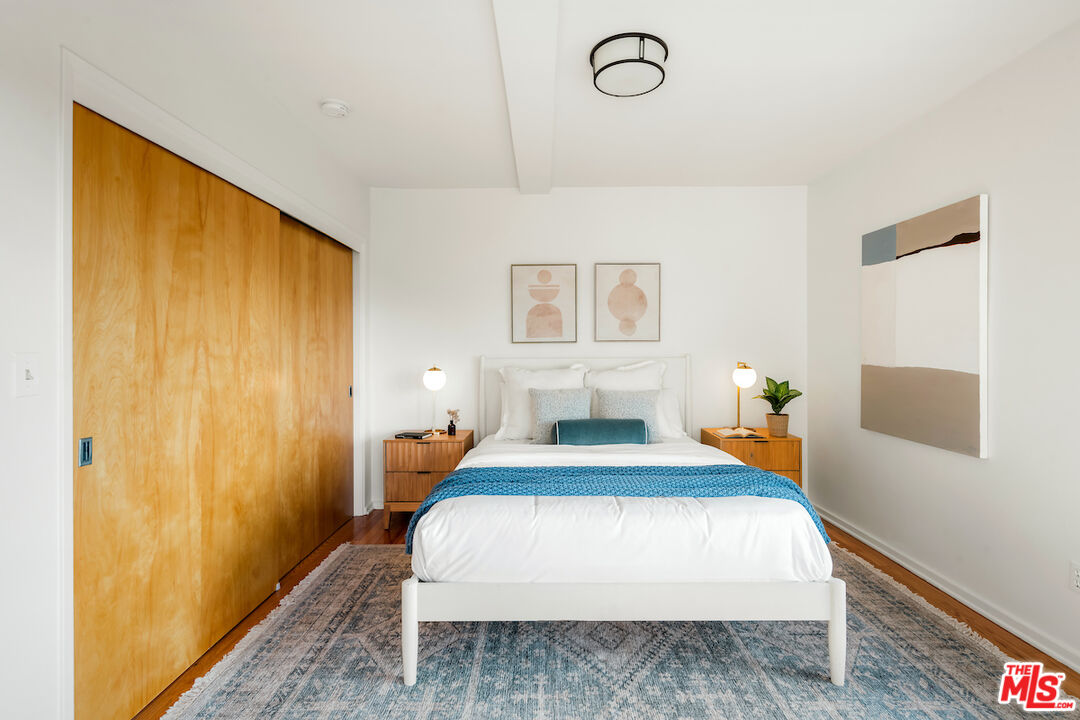 13201 Cheltenham Drive Sherman Oaks, CA 91423 - Photo 31 of 75 a bedroom with a bed and wooden floor