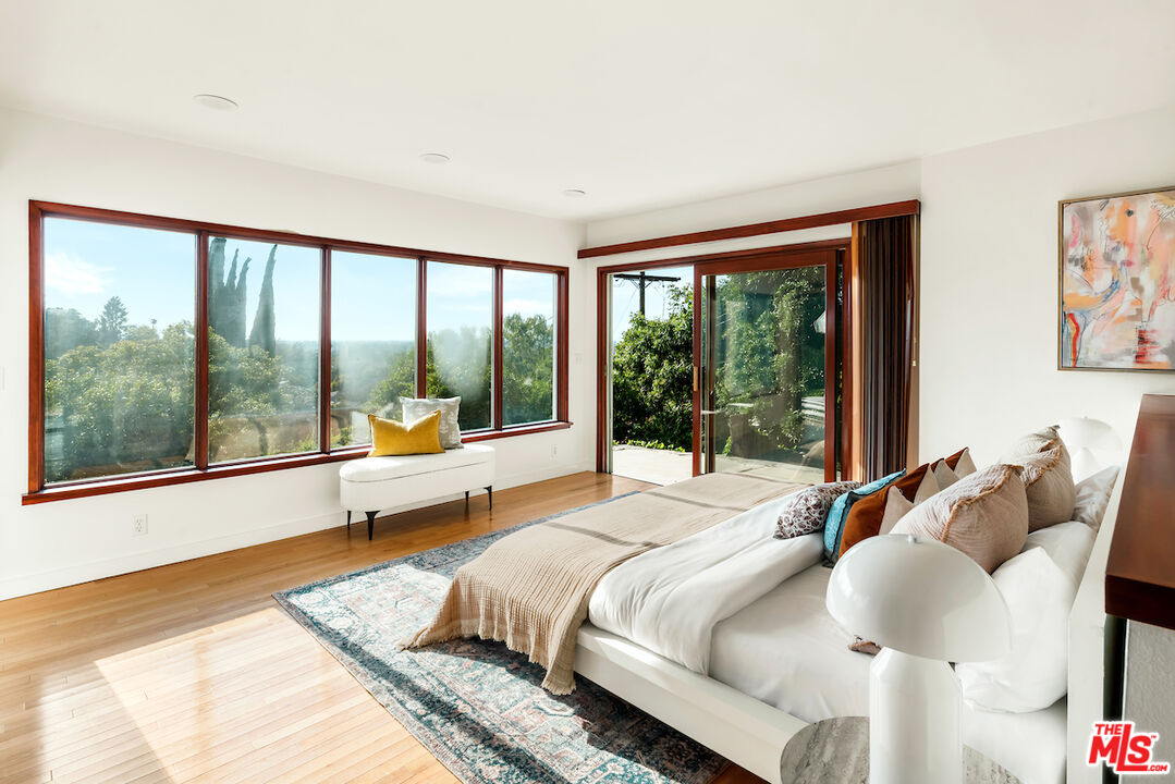 13201 Cheltenham Drive Sherman Oaks, CA 91423 - Photo 35 of 75 a bedroom with a bed and glass window