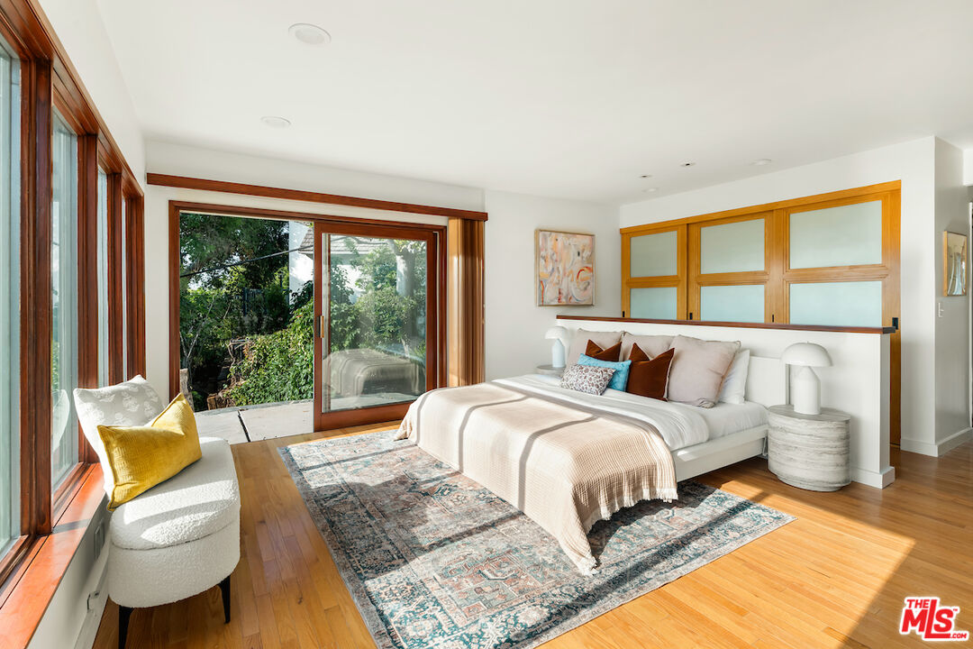 13201 Cheltenham Drive Sherman Oaks, CA 91423 - Photo 36 of 75 a bedroom with a bed and glass window