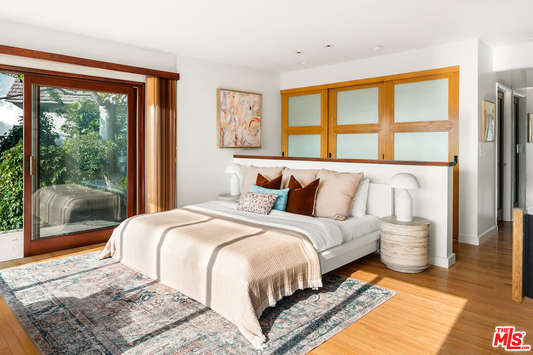 13201 Cheltenham Drive Sherman Oaks, CA 91423 - Photo 37 of 75 a bedroom with a large bed and a large window