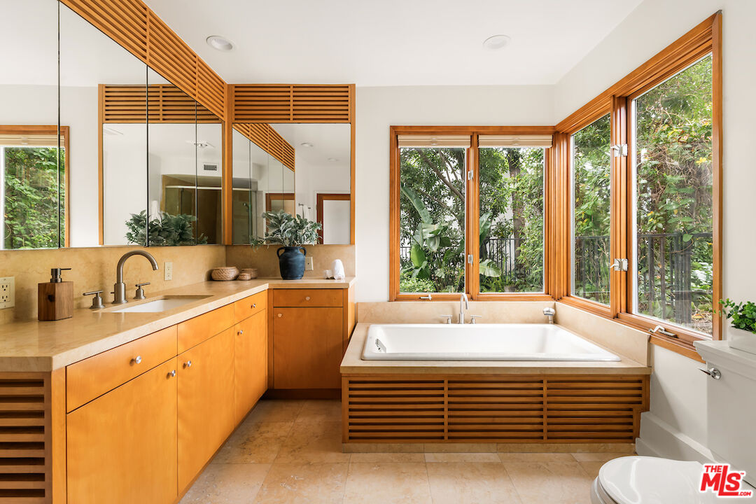 13201 Cheltenham Drive Sherman Oaks, CA 91423 - Photo 43 of 75 a spacious bathroom with a tub and large windows