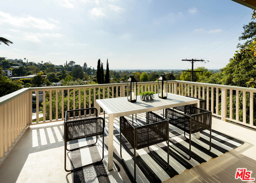 13201 Cheltenham Drive Sherman Oaks, CA 91423 - Photo 57 of 75 a view of a chairs and table on the deck