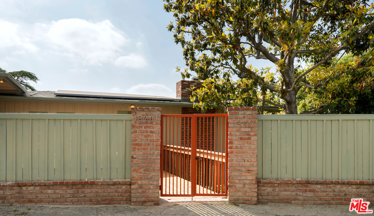 13201 Cheltenham Drive Sherman Oaks, CA 91423 - Photo 69 of 75 a view of a backyard with wooden fence