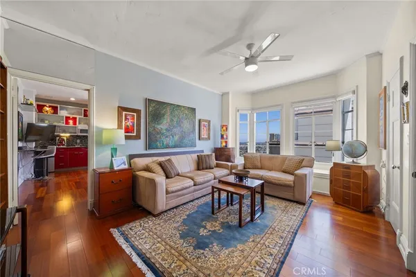 a living room with furniture rug and wooden floor