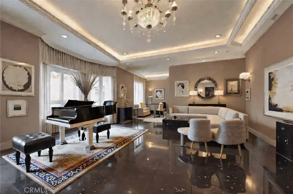a living room with furniture a rug and a chandelier