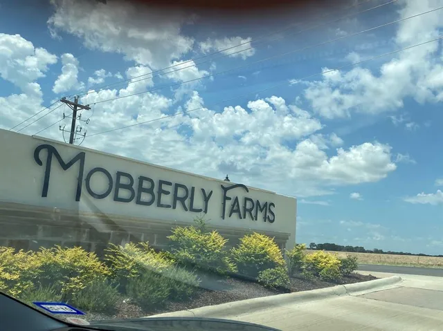 a kitchen with granite countertop a sink stove and refrigerator