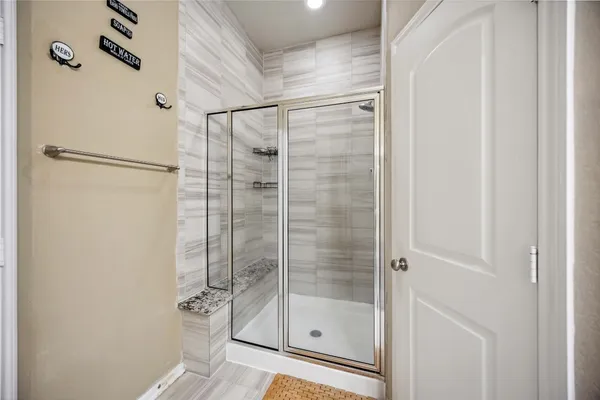 a bathroom with a glass shower door