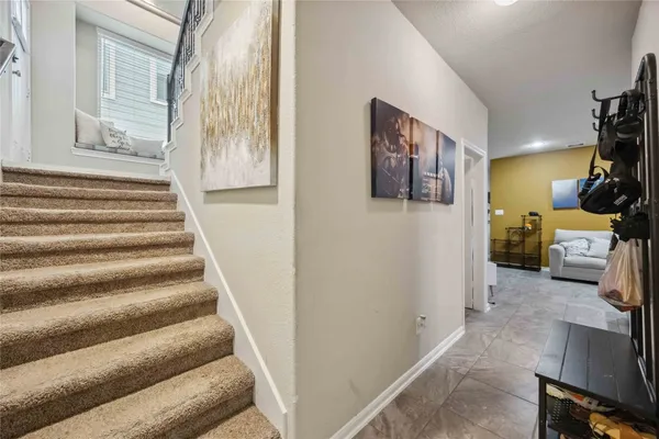 a view of a hallway with couches and a fireplace
