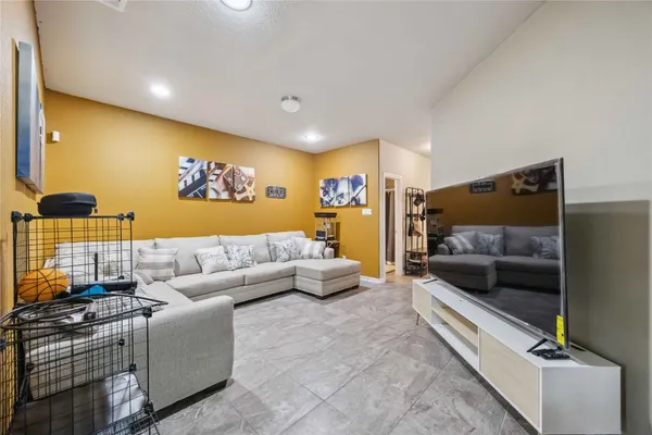 a living room with furniture and a flat screen tv