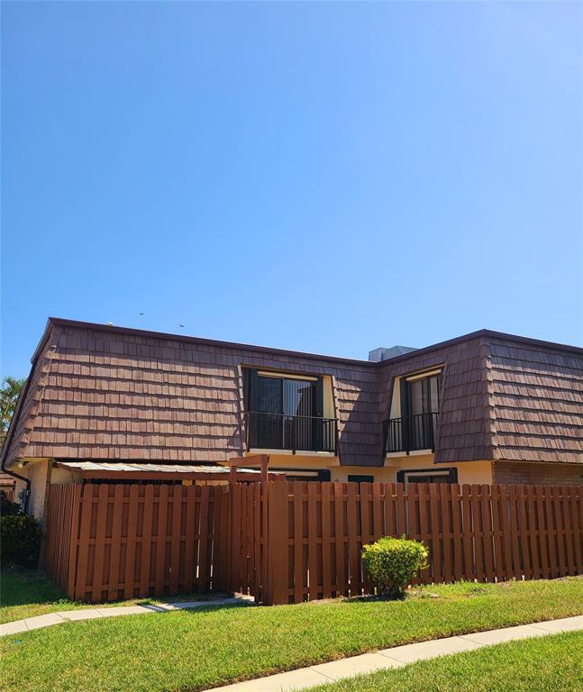 912 Springdale Circle, Unit 912 Palm Springs, FL 33461 - Photo 14 of 15 a view of a house with backyard and wooden fence