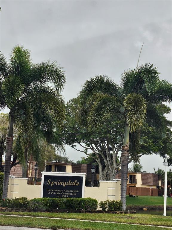 912 Springdale Circle, Unit 912 Palm Springs, FL 33461 - Photo 15 of 15 a sign board with tree in the background