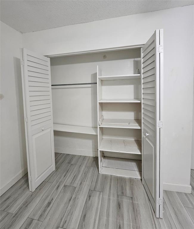 912 Springdale Circle, Unit 912 Palm Springs, FL 33461 - Photo 8 of 15 a view of walk in closet with empty racks