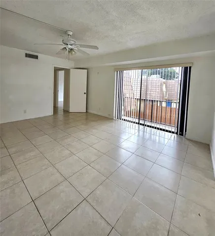 a view of an empty room and a window