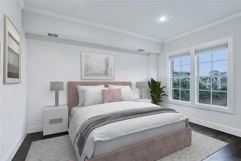 a bedroom with bed and painting on the wall